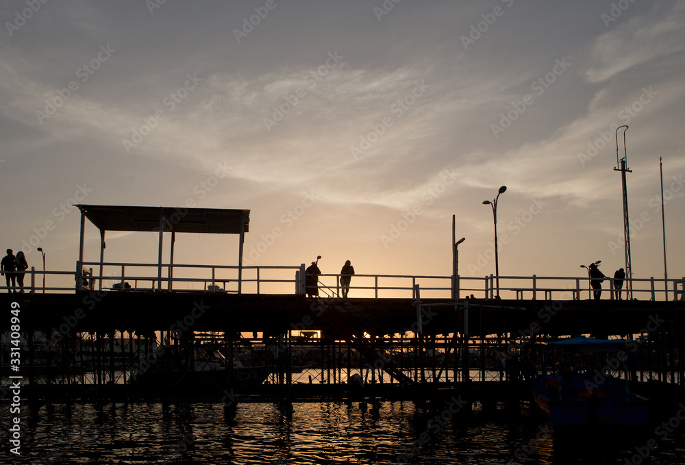 Sunset at harbour Illo Peru. Pier. Construction