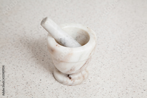 Granite white mortar and pestle with selective focus