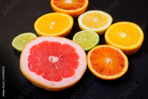 Fresh citrus fruit on black background