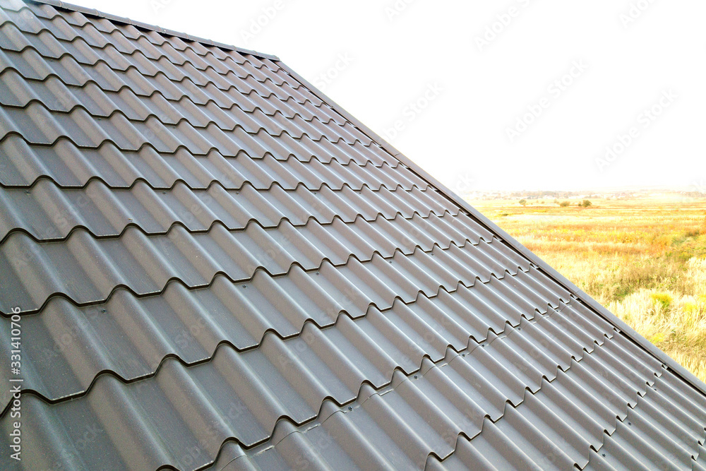 Close up of new house roof structure covered with metal tile sheets. Close up of new house roof structure covered with metal tile sheets.
