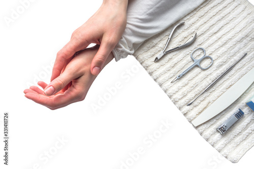 Tools for manicure and women hands on white background.