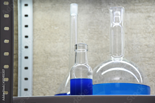 blue liquids in flasks for chemical and laboratory research