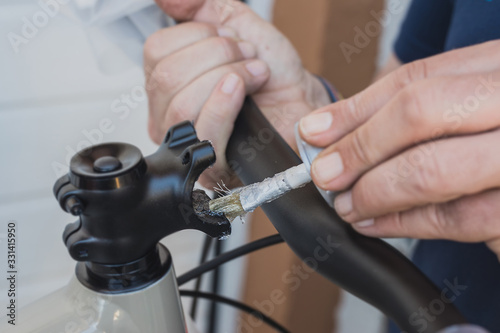 Greasing of a bicycle handlebar stem with the use of a small paintbrush. © Anze