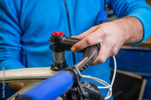 Bicycle mechanic assembling a bicycle stem on a fork tube