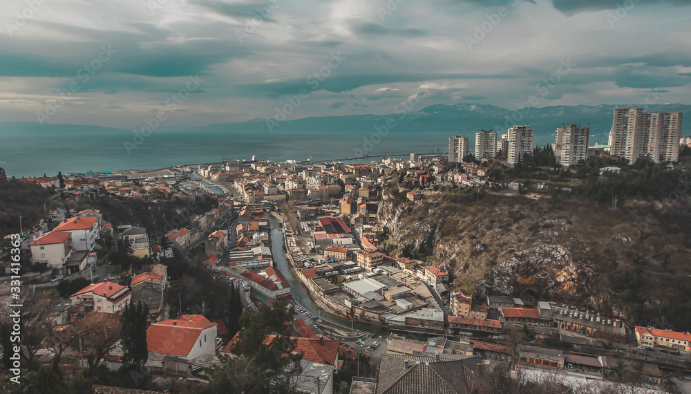 Panoramic view from the castle of Trsat over the city of Rijeka, Croatia on a cold winter day with some clouds.