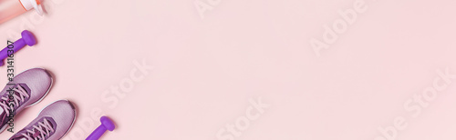 Sports equipment and shoes for women's training. Pink background, web banner.