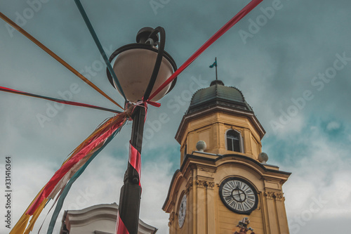 City of Rijeka, Croatia clock tower, in a festive spirit. Lantern standing next to the church is covered with colorful ornaments. photo