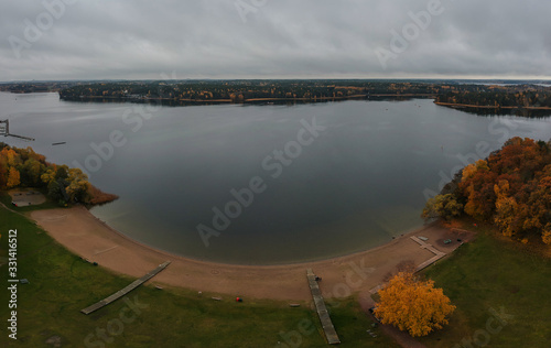 Typical swedish beach or coast close to Stockholm at H  sselby strand  on a cold cloudy autumn day. Drone panorama of a popular beach around Stockholm