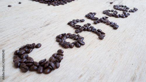 dark rose coffee bean  Black coffee cup on old wooden table top view.