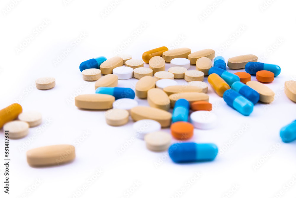 Colored pills on an isolated white background. Coronavirus vaccine. Place for text.