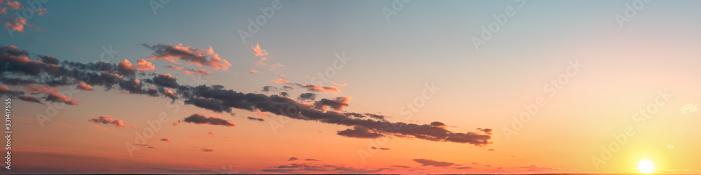 sunset panorama with clouds on a blue sky background