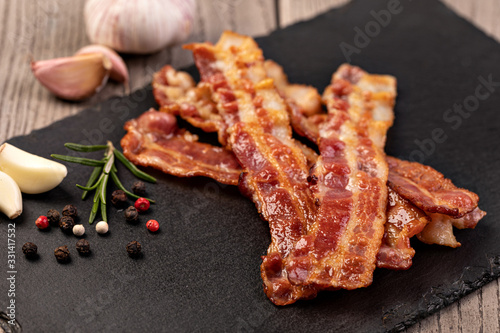 Closeup of slices of crispy hot fried bacon