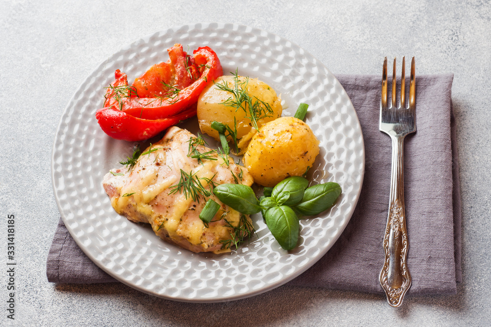 Baked potatoes with chicken and vegetables on a plate.
