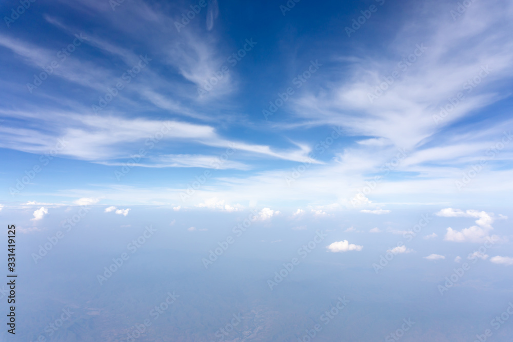 Skyscape view from clear glass window seat from aircraft to cloudscape, traveling on white fluffy clouds and vivid blue sky in a suny day Skyscape view from clear glass window seat from aircraft to cloudscape, traveling on white fluffy clouds and vivid blue sky in a suny day