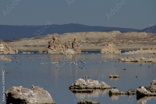 Fotografia many rocks protrude from the water of the lake which is quite low
