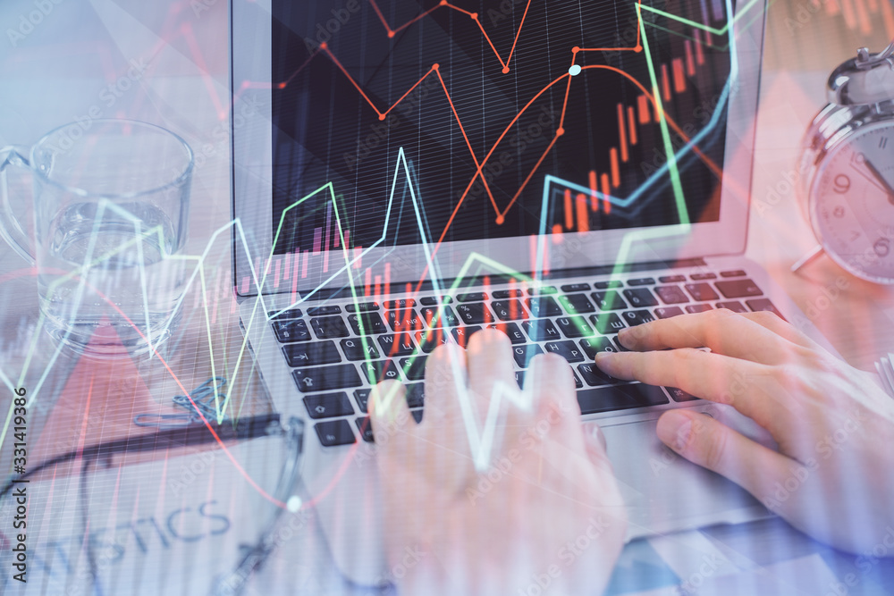 Multi exposure of market chart with man working on computer on background. Concept of financial analysis. Multi exposure of market chart with man working on computer on background. Concept of financial analysis.