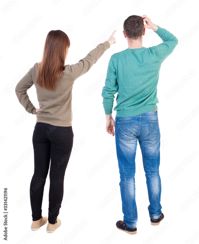 Back view of couple in sweater pointing. Back view of couple in sweater pointing.