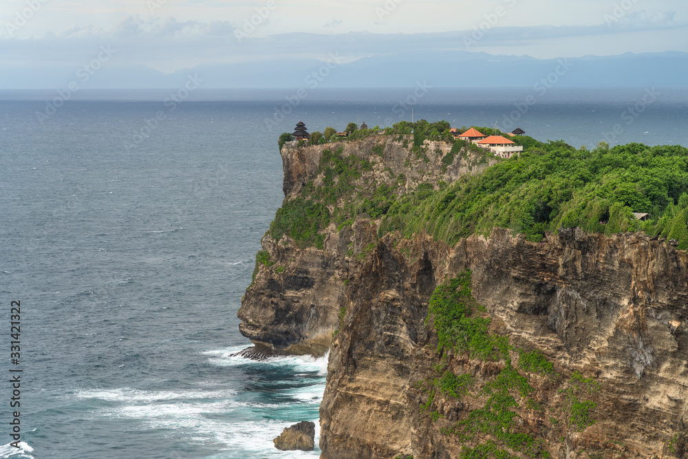 Panoramic view of Uluwatu Temple seen from Karang Boma Cliff before the storm, Bali - Indonesia