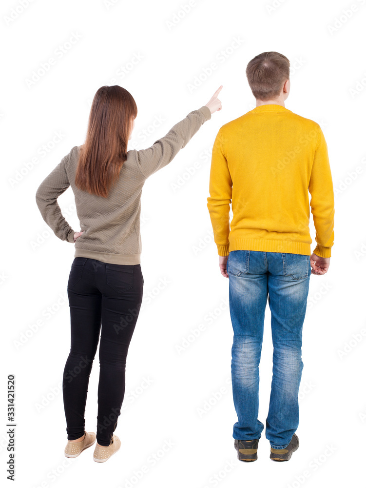 Back view of couple in sweater pointing. Back view of couple in sweater pointing.