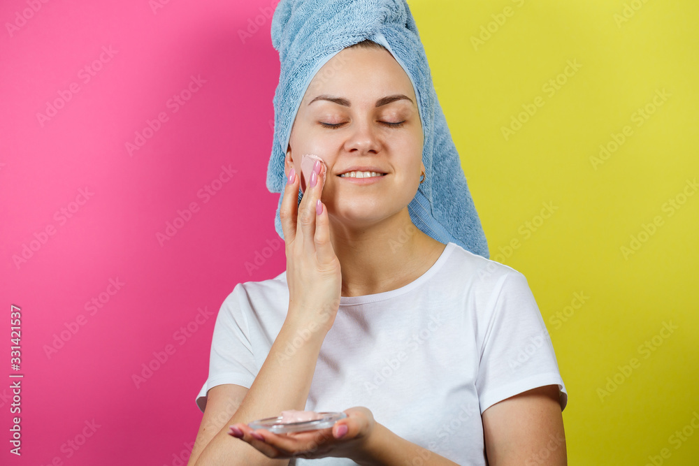 Portrait of a beautiful young girl who puts a refreshing mask on her face to rejuvenate and tone the skin. Beauty treatments Portrait of a beautiful young girl who puts a refreshing mask on her face to rejuvenate and tone the skin. Beauty treatments