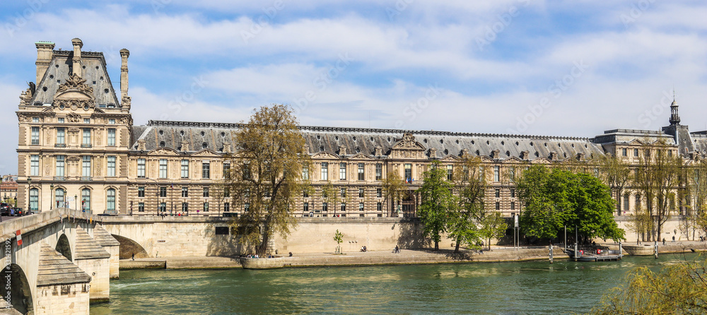 Beautiful historic buildings of Paris and one of the oldest bridge ( Pont Royal ) across Seine River. France. April 2019
