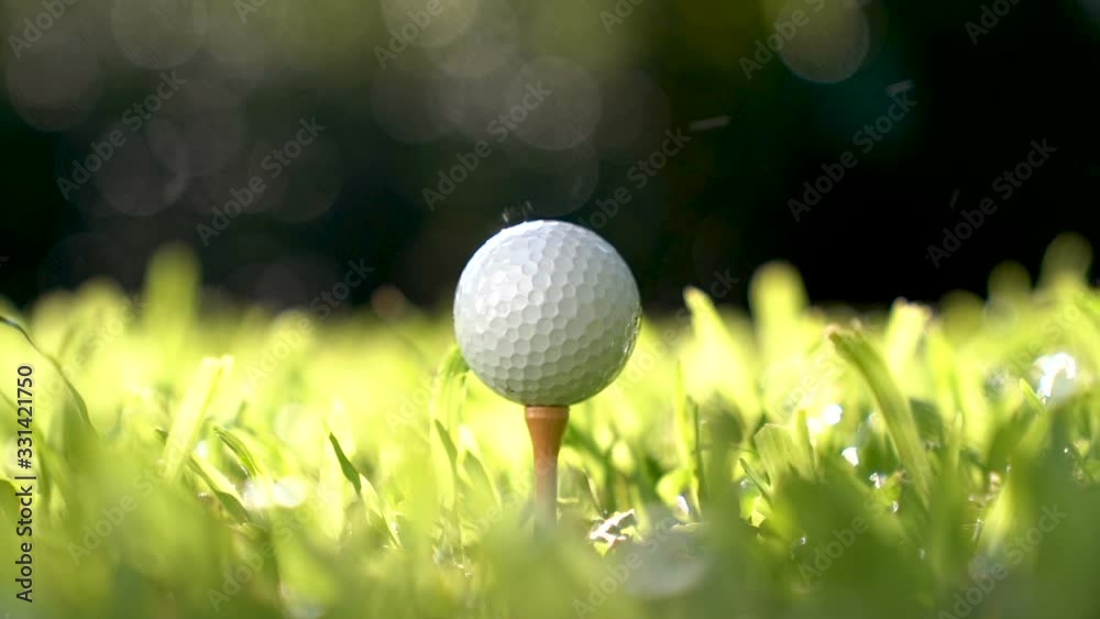 Golfer hitting golf ball - slow motion .