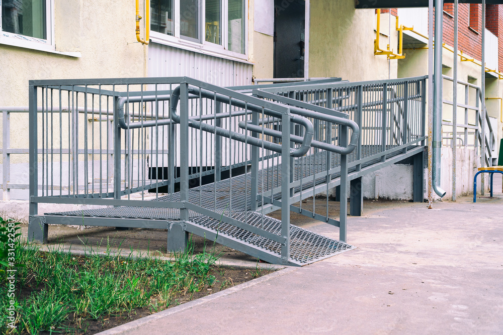 Ramp for the disabled at the entrance to the entrance of residential building Ramp for the disabled at the entrance to the entrance of residential building