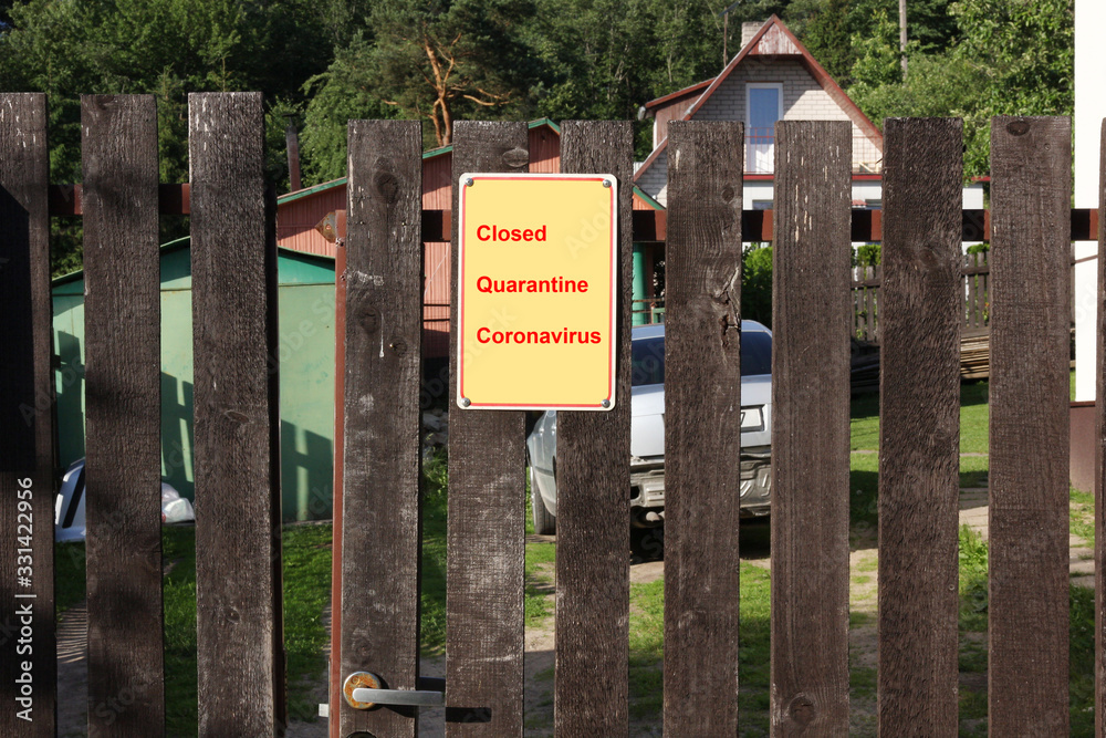 A warning is hanging on the fence of a rural European house- Closed Quarantine - Coronavirus A warning is hanging on the fence of a rural European house- Closed Quarantine - Coronavirus