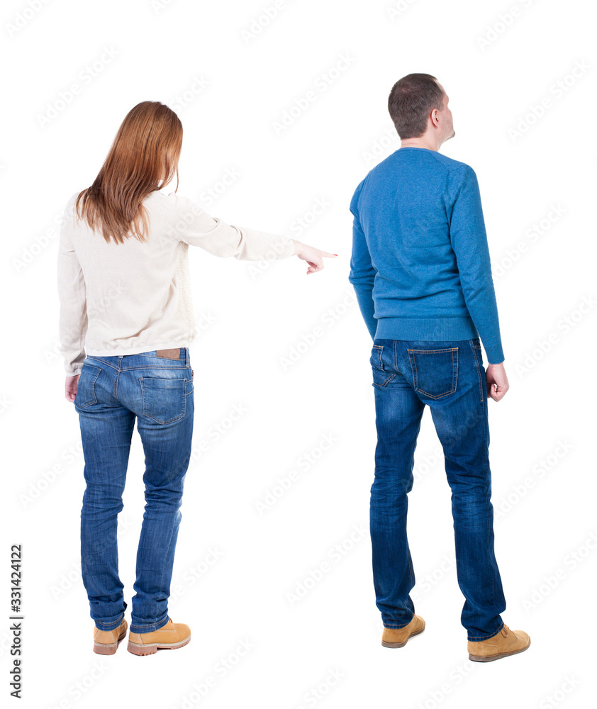 Back view of couple in sweater pointing. Back view of couple in sweater pointing.
