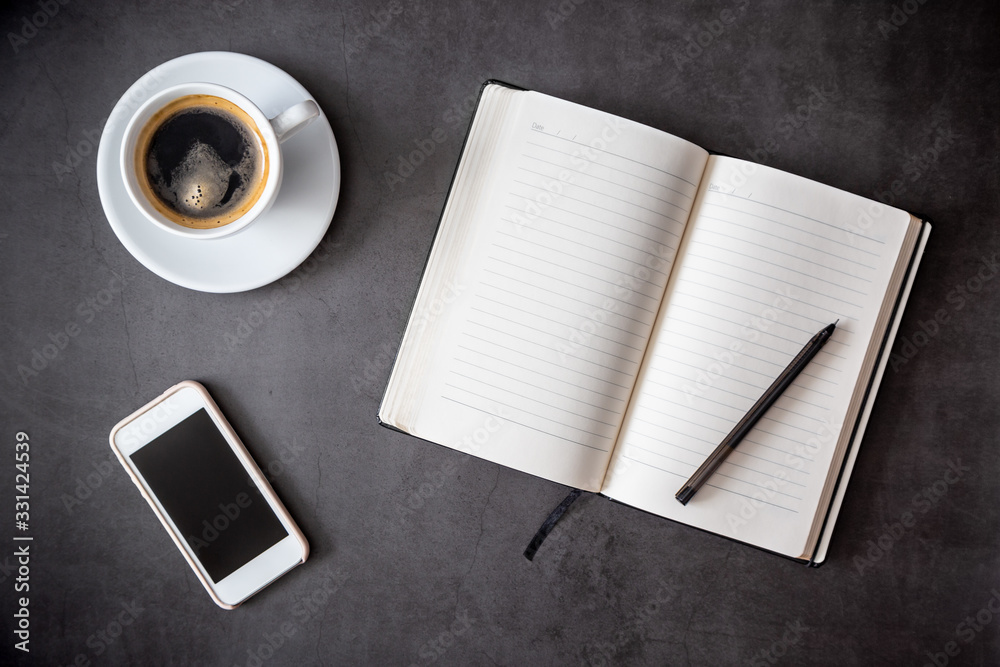 Business flatlay. Minimalism. Notepad, pen, phone and a cup of coffee. Time for reflection. Entries in the diary. Top view Business flatlay. Minimalism. Notepad, pen, phone and a cup of coffee. Time for reflection. Entries in the diary. Top view