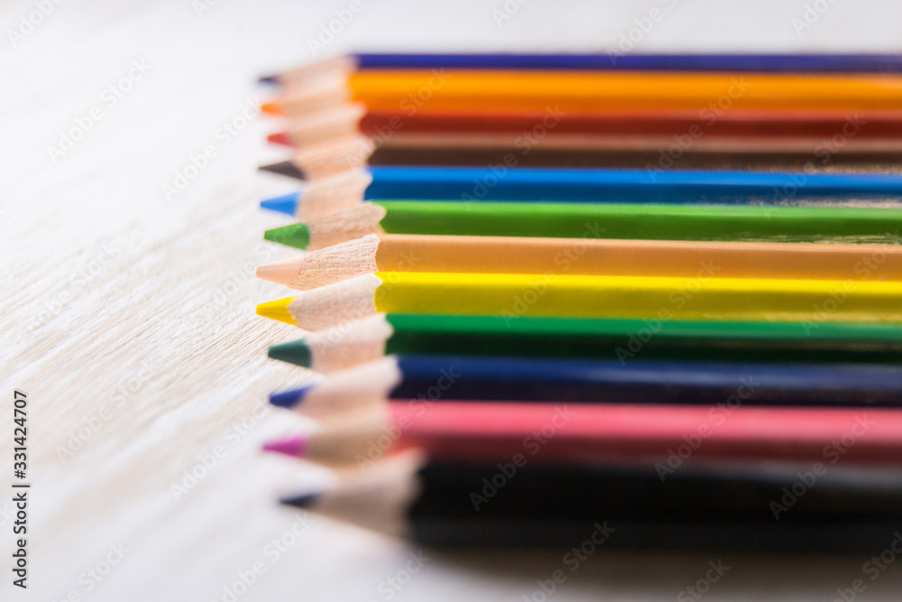 Various color pencils lie on the table isolated Various color pencils lie on the table isolated