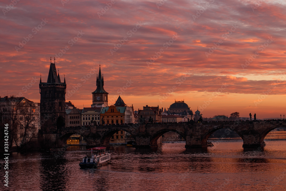 Colorful sunset and charles bridge on the background. Orange sky in Prague. 