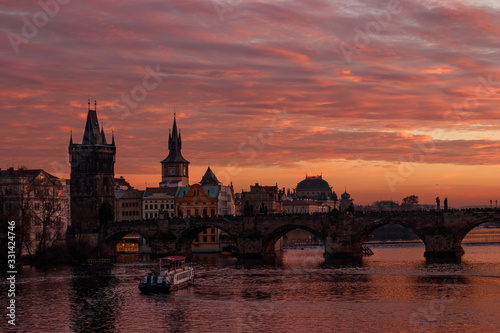 Colorful sunset and charles bridge on the background. Orange sky in Prague. 
