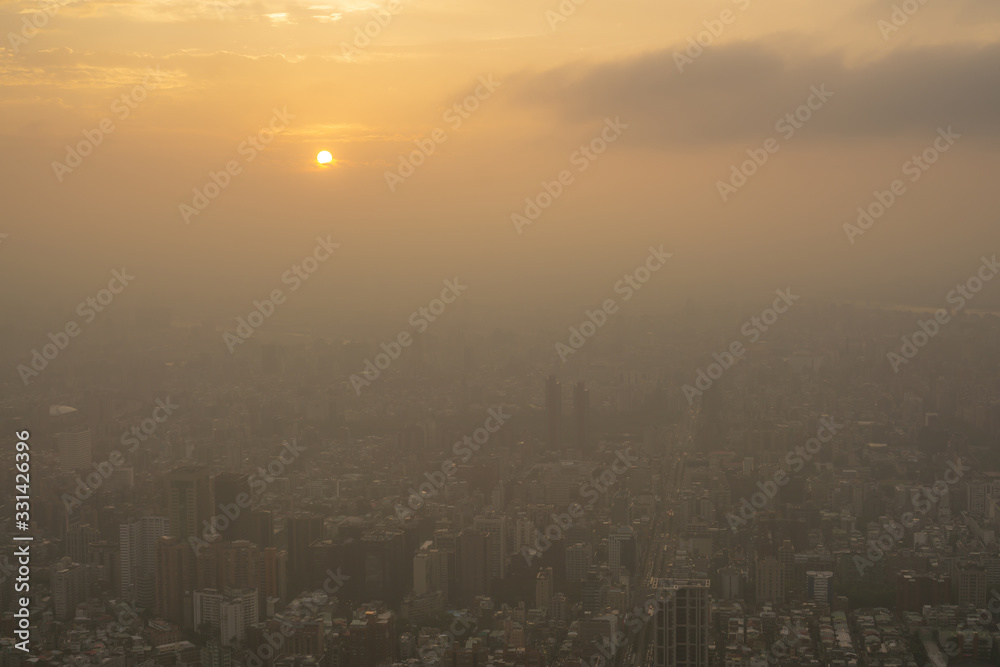 Beautiful sunset scene above the building, orange light and the mist cover all over the city Beautiful sunset scene above the building, orange light and the mist cover all over the city