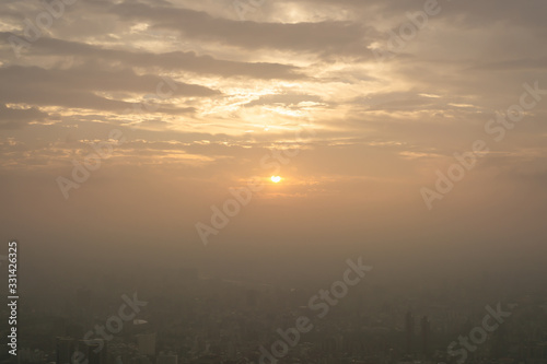 Beautiful sunset scene above the building  orange light and the mist cover all over the city