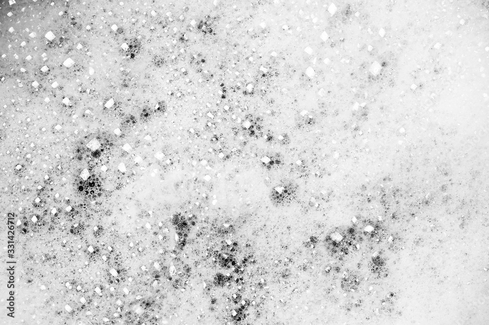 White soap bubbles on water. Bubbles on a white background.
