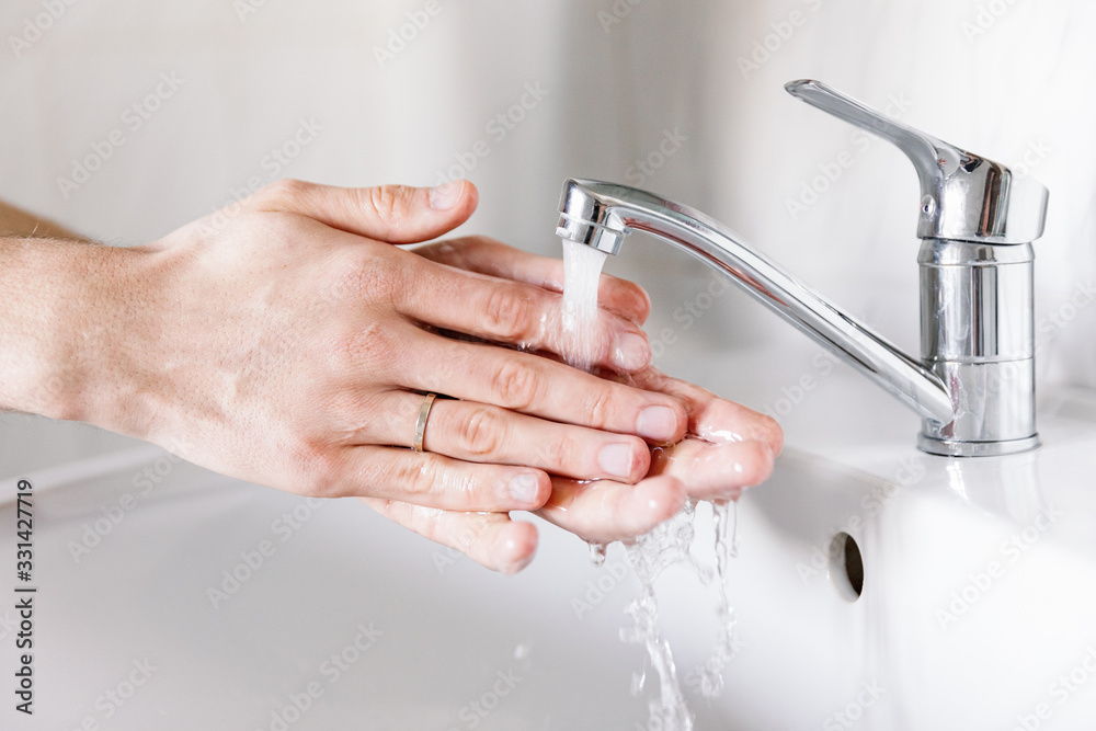Washing hands under the water tap or faucet without soap. Global Hand