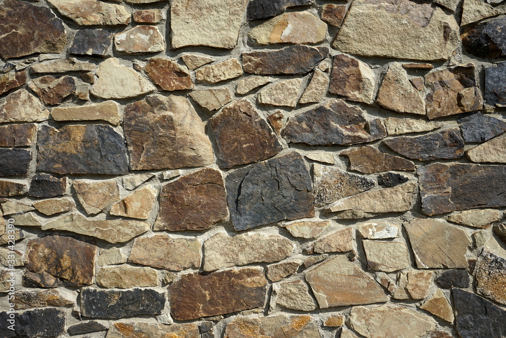 Background texture of an old wall built of different stone Background texture of an old wall built of different stone