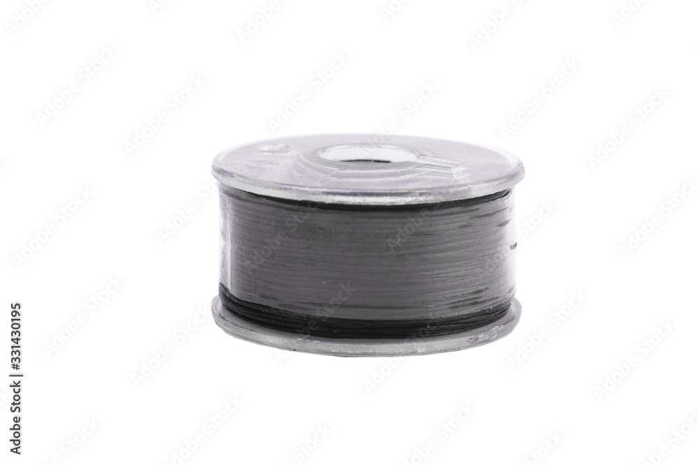 A spool of thread from a sewing machine on a white background isolated A spool of thread from a sewing machine on a white background isolated