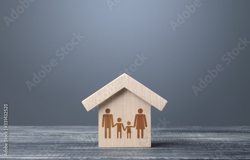 Drawing symbol of a family in a house. Mortgage loan. Providing the population with the possibility of acquiring real estate. Preferential programs of cheap housing for young families. Unit of society
