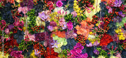 Various color flower background wall with amazing red,orange,pink,purple,green and white various flowers ,Wedding decoration, hand made Beautiful flower wall background 