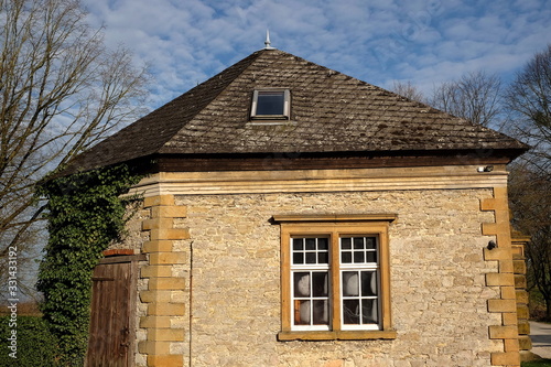 Schönes Sprossenfenster in alter Fassade aus Sandstein in Beige und Naturfarben im Sonnenschein am Gut Barkhausen in Asemissen bei Leopoldshöhe und Bielefeld am Teutoburger Wald in Ostwestfalen-Lippe photo