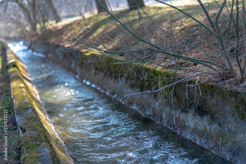 The river flows in the park along the canal