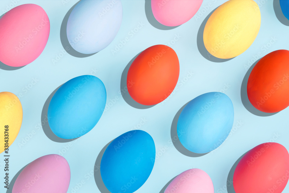 Painted eggs on pastel background.