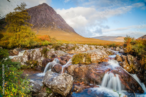 Small waterfall with Buachaille Etive Mor, mountain in Glencoe