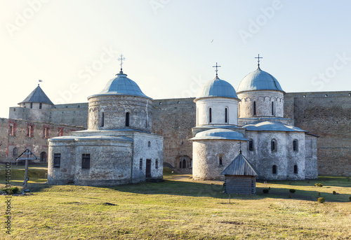 An old church in a medieval dilapidated fortress. White stone Christian church.