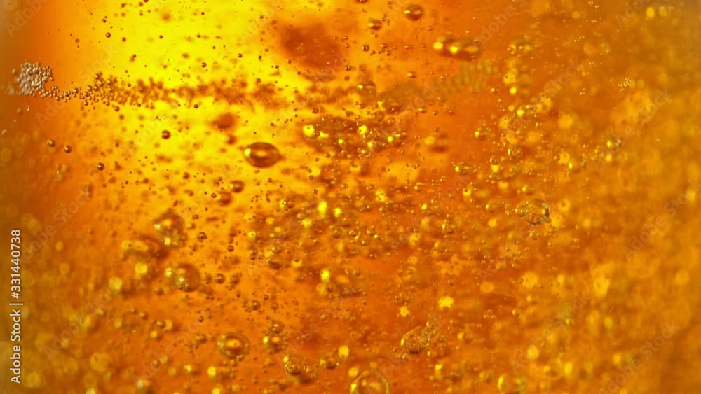 Super Slow Motion Detail Shot of Beer Bubbles in Glass at 1000fps.