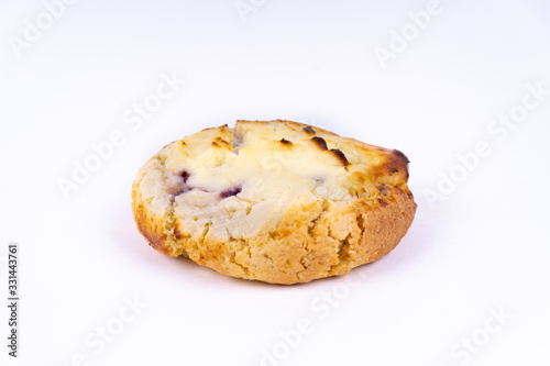 A cookie cheesecake with blueberries on white background with copy space - angled view