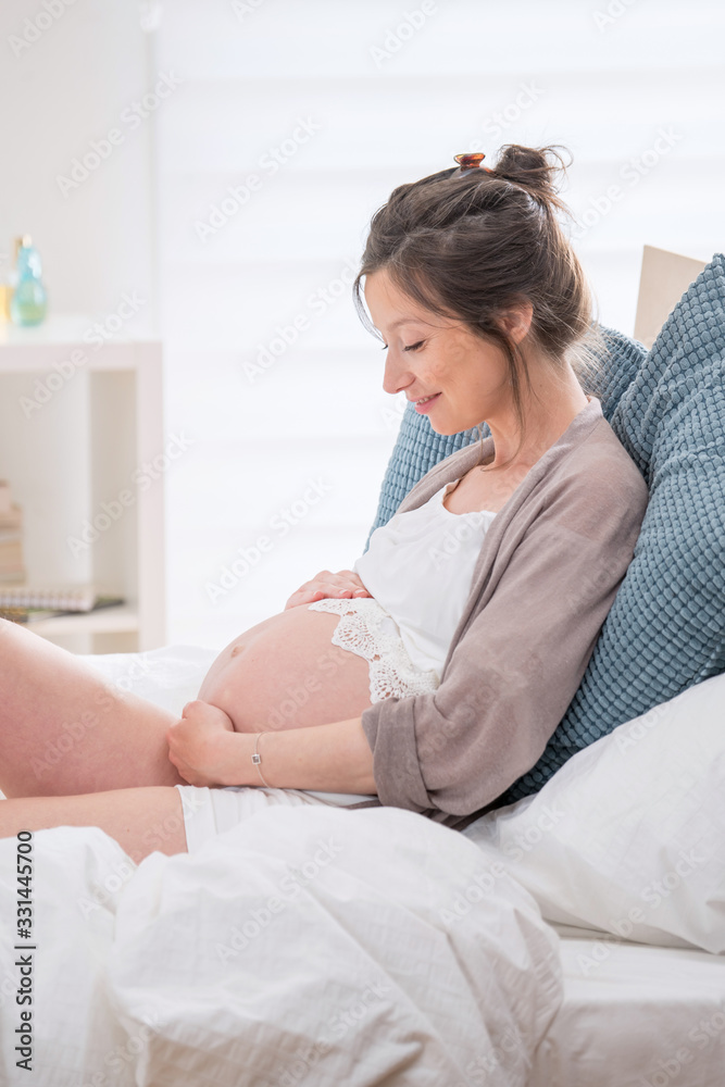 Young pregnant woman resting in her room at home Young pregnant woman resting in her room at home