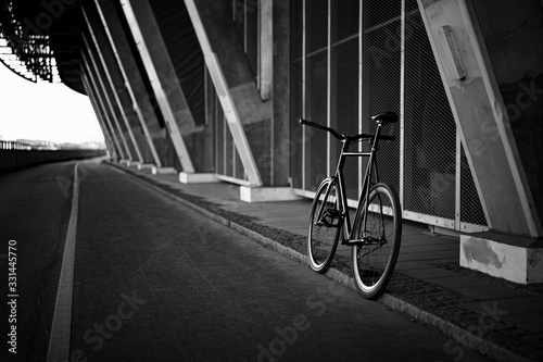 Black fixedgear road bicycle on a side of the road photo